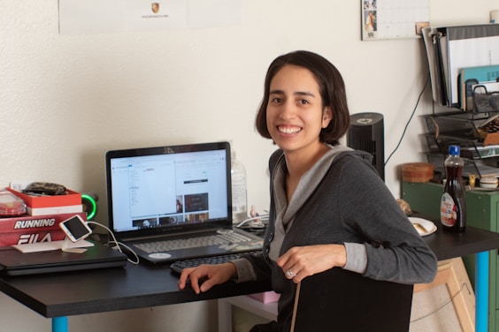 Team member smiling with laptop